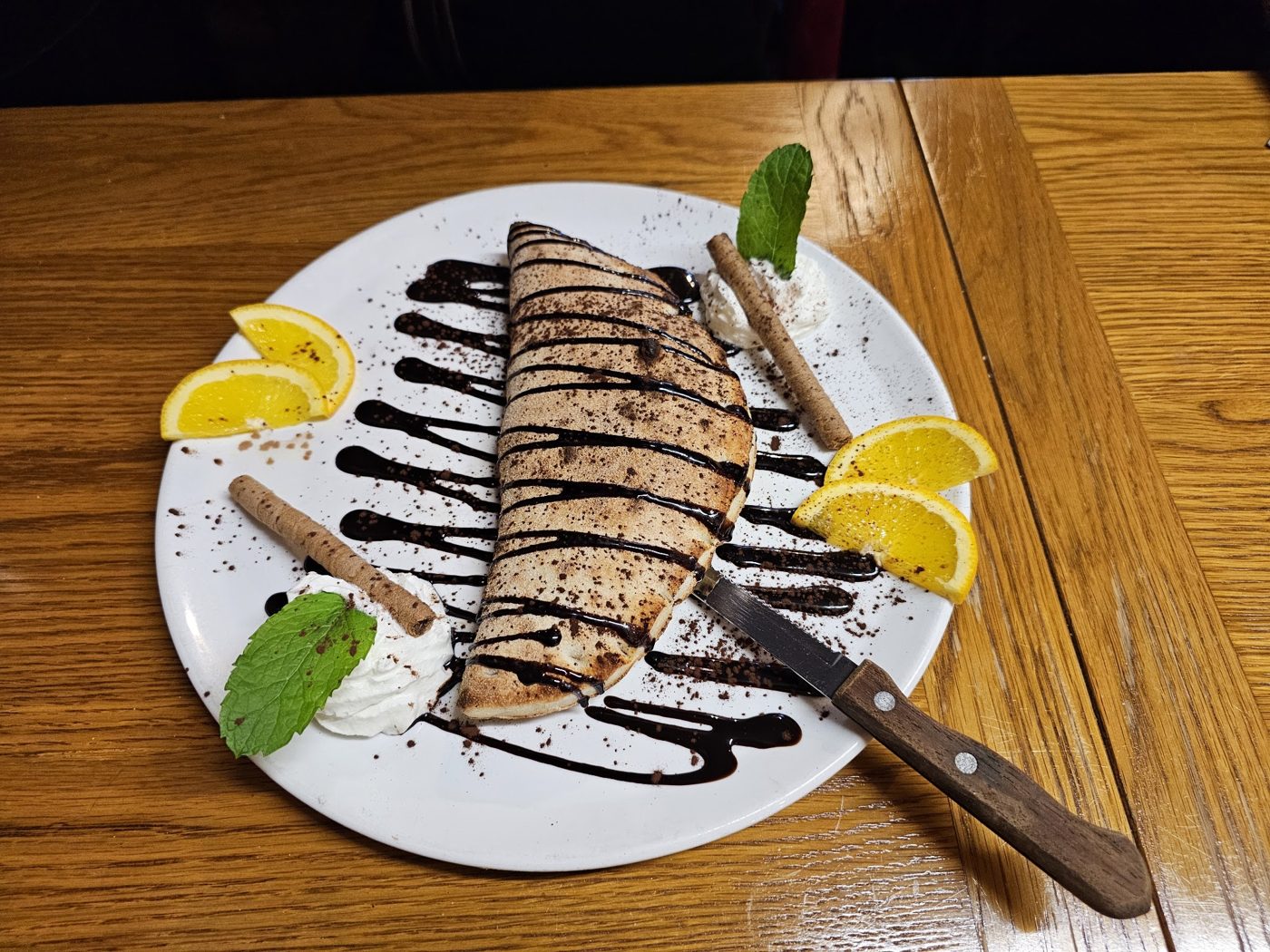 A crêpe drizzled with chocolate sauce